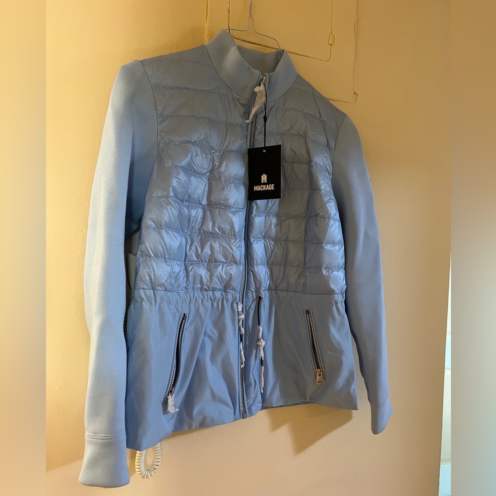 Woman’s light Mackage coat.